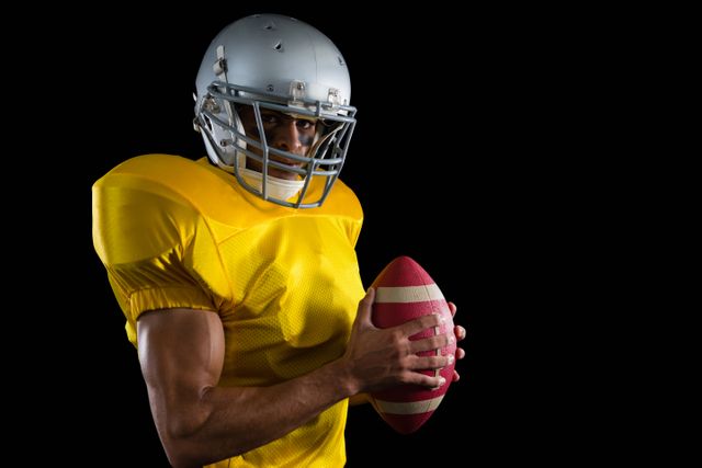 American football player holding a ball with both his hands - Download Free Stock Photos Pikwizard.com