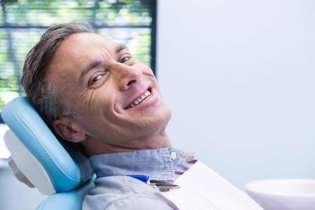 Portrait of smiling man sitting on chair - Download Free Stock Photos Pikwizard.com