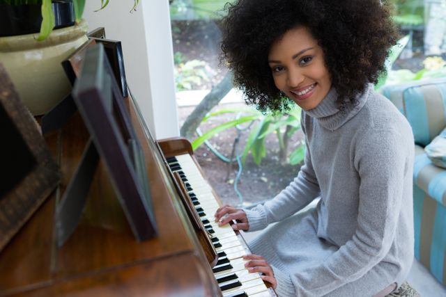 Portrait of beautiful woman playing piano at home