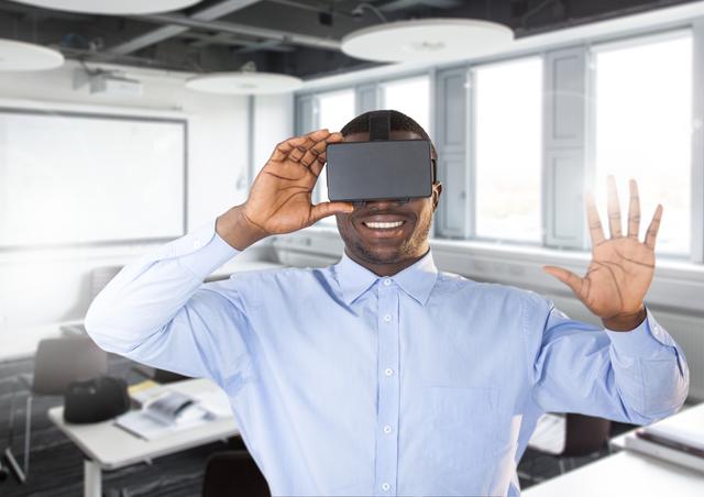 Smiling man using virtual reality headset in office
