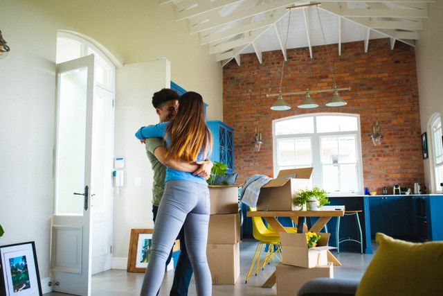 Happy young multiracial man embracing woman while dancing in living room at home - Download Free Stock Photos Pikwizard.com