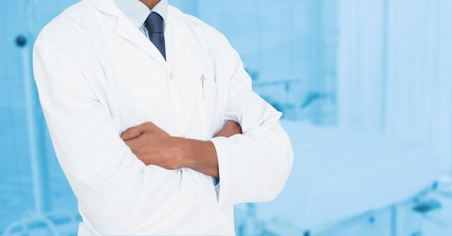 Mid-section of male doctor standing with arms crossed - Download Free Stock Photos Pikwizard.com