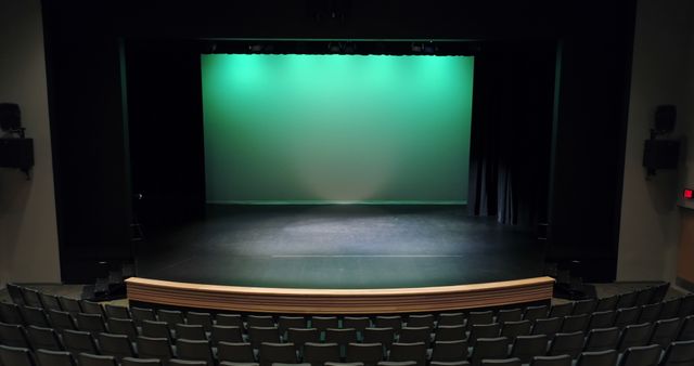 Theatre with green screen, curtain up, stage and empty seats - Download Free Stock Photos Pikwizard.com