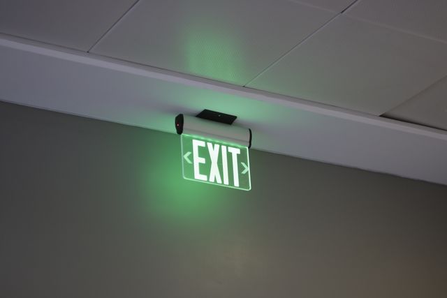 an exit sign that is lit up - Download Free Stock Photos Pikwizard.com