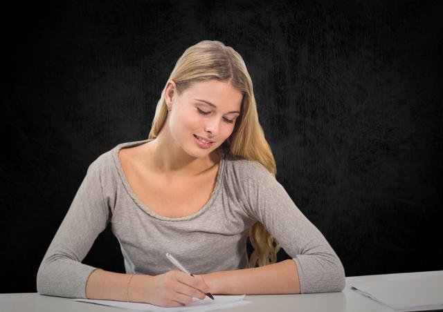 Woman writing on a piece of paper against black background - Download Free Stock Photos Pikwizard.com
