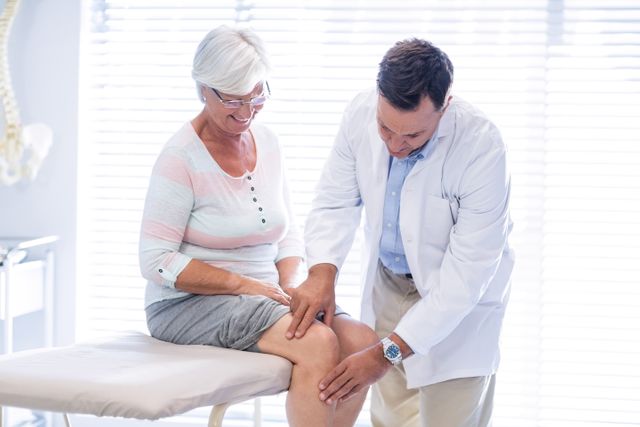 Physiotherapist giving knee therapy to senior woman - Download Free Stock Photos Pikwizard.com