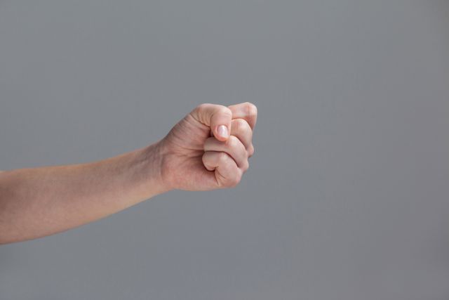 Close-up of clenched fist of a woman - Download Free Stock Photos Pikwizard.com
