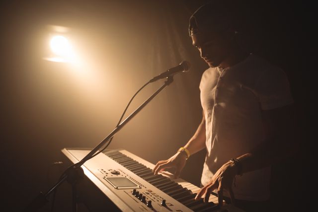 Male singer playing piano in nightclub - Download Free Stock Photos Pikwizard.com