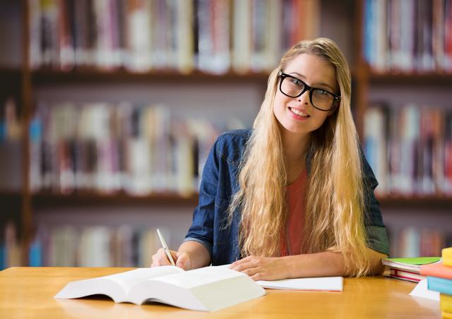 Girl in spectacles studying in library - Download Free Stock Photos Pikwizard.com