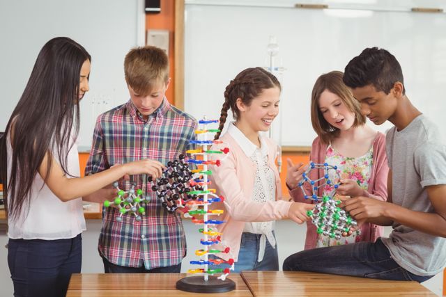 Happy school kids experimenting molecule model in laboratory - Download Free Stock Photos Pikwizard.com