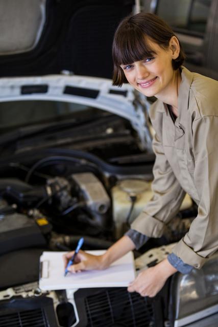 Portrait of female mechanic preparing a check list - Download Free Stock Photos Pikwizard.com
