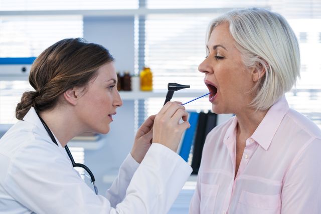 Doctor examining patients teeth with otoscope - Download Free Stock Photos Pikwizard.com