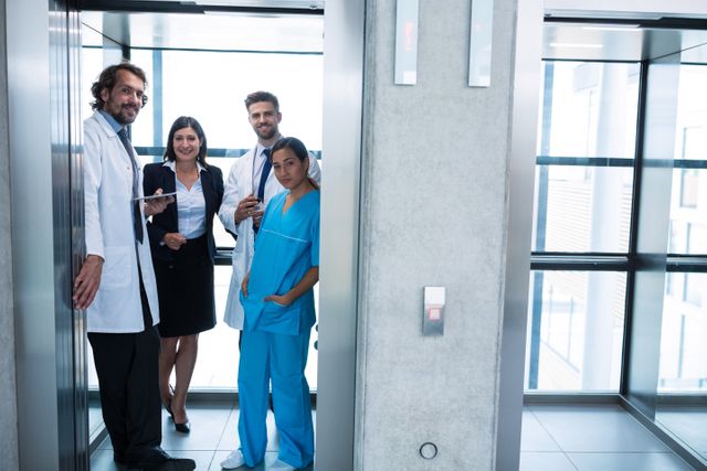 Doctors and businesswoman standing in elevator - Download Free Stock Photos Pikwizard.com