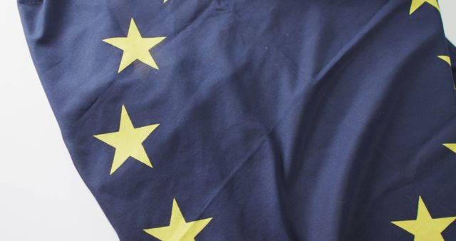Image of creased flag of european union lying on white background. nationality, state symbols, patriotism and independence concept.