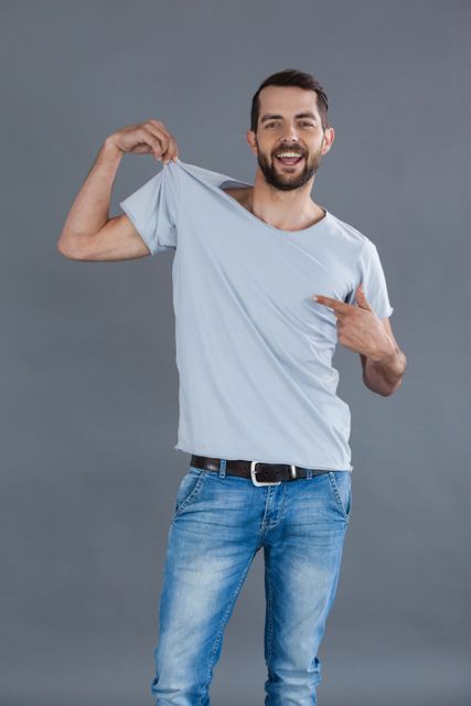 Cheerful man posing in grey t-shirt  - Download Free Stock Photos Pikwizard.com