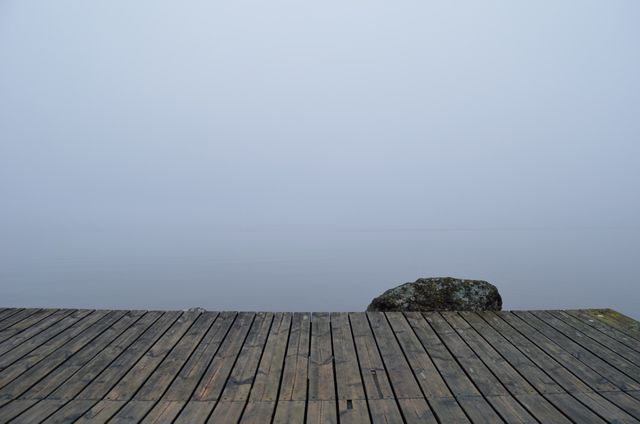 a dock with a rock on it - Download Free Stock Photos Pikwizard.com