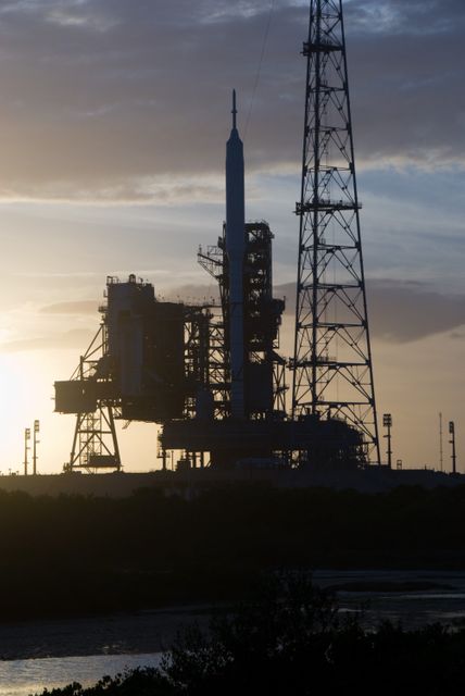 CAPE CANAVERAL, Fla. - Sunset at Launch Pad 39B at NASA's Kennedy Space Center in Florida finds the Ares I-X rocket awaiting the approaching liftoff of its flight test.    This is the first time since the Apollo Program's Saturn rockets were retired that a vehicle other than the space shuttle has occupied the pad.   Part of the Constellation Program, the Ares I-X is the test vehicle for the Ares I.  The Ares I-X flight test is set for Oct. 27.  For information on the Ares I-X vehicle and flight test, visit http://www.nasa.gov/aresIX. Photo credit: NASA/Kim Shiflett