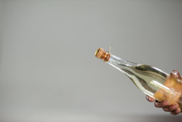 Hand holding champagne bottle - Download Free Stock Photos Pikwizard.com