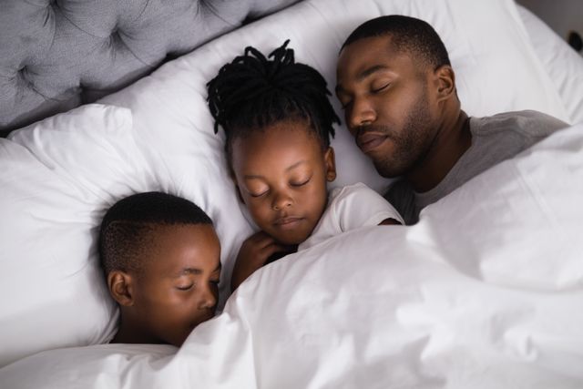 Father with children sleeping together on bed at home - Download Free Stock Photos Pikwizard.com