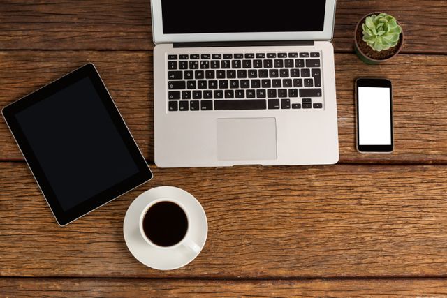 Digital tablet, laptop and smartphone with cup of coffee - Download Free Stock Photos Pikwizard.com