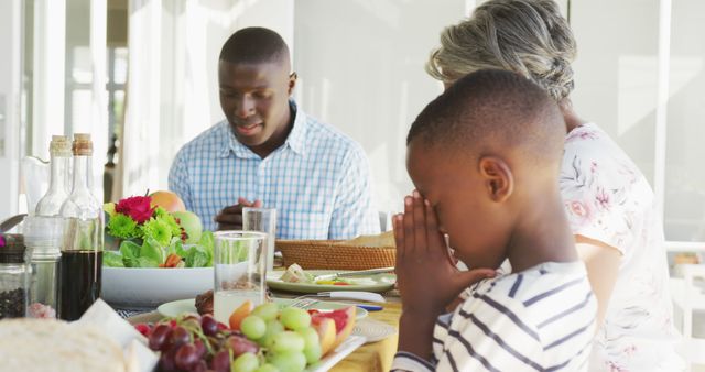 Image of african american family praying together before meal - Download Free Stock Photos Pikwizard.com