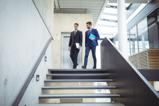 Two businessman walking down the stairs - Download Free Stock Photos Pikwizard.com