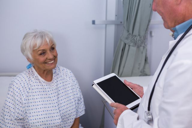 Doctor interacting with senior patient in ward - Download Free Stock Photos Pikwizard.com