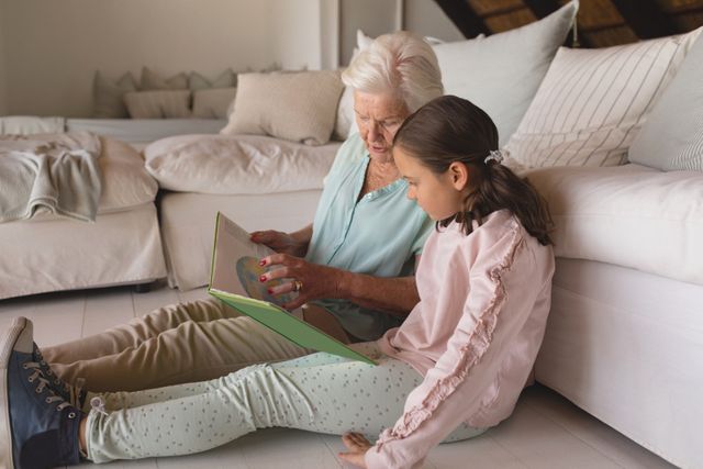 Grandmother and granddaughter reading story book - Download Free Stock Photos Pikwizard.com