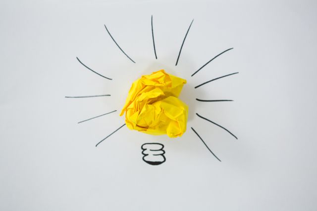 Light bulb drawn around crumbled Yellow paper - Download Free Stock Photos Pikwizard.com