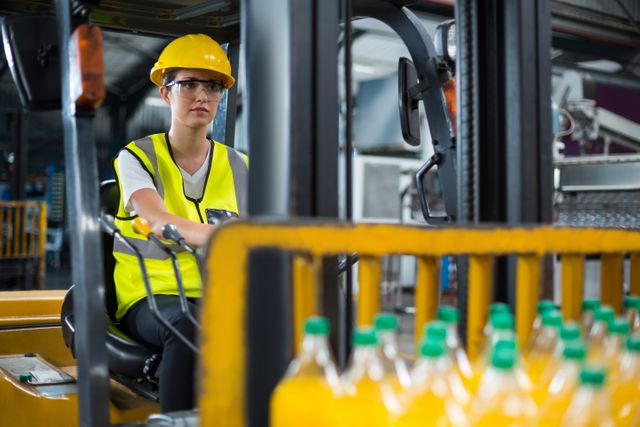 Female factory worker driving forklift in factory - Download Free Stock Photos Pikwizard.com