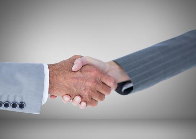 Handshake of Business people against grey background - Download Free Stock Photos Pikwizard.com
