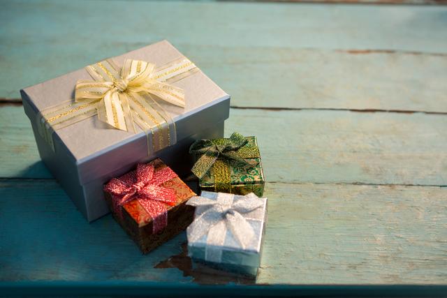 Wrapped gifts on wooden plank - Download Free Stock Photos Pikwizard.com