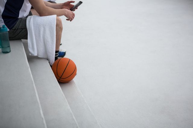 Basketball player using mobile phone - Download Free Stock Photos Pikwizard.com
