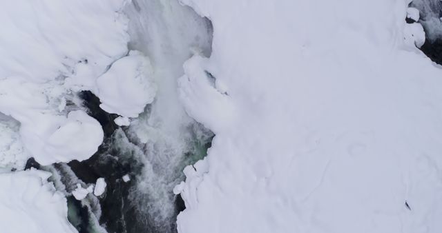 Aerial of stream flowing on snowy area during winter 4k