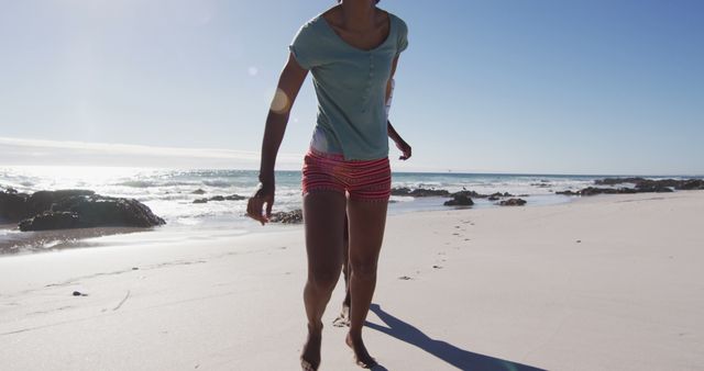 African american couple holding hands and running on the beach - Download Free Stock Photos Pikwizard.com
