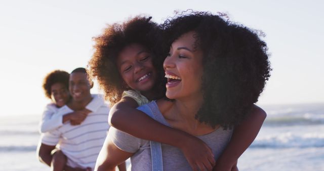 Happy mother giving her son a piggyback ride in the city stock photo