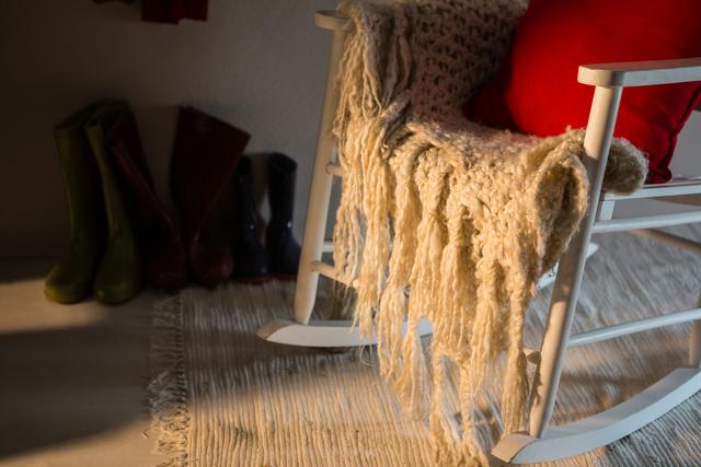 Wooden chair with red pillow and woolen blanket - Download Free Stock Photos Pikwizard.com