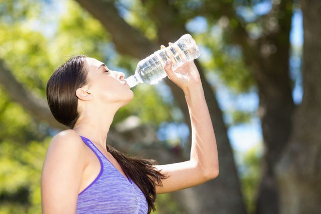 Woman drinking water from water bottle - Download Free Stock Photos Pikwizard.com