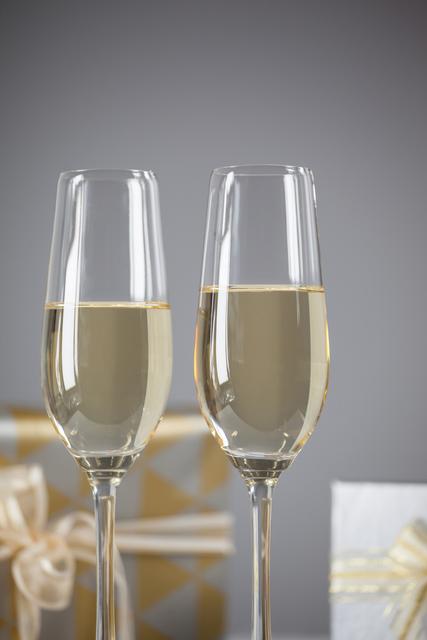 Two champagne flutes and Christmas gifts - Download Free Stock Photos Pikwizard.com