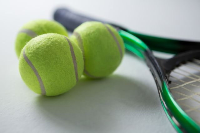 Close up of tennis balls with racket - Download Free Stock Photos Pikwizard.com
