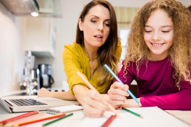 Mother assisting her daughter in drawing - Download Free Stock Photos Pikwizard.com