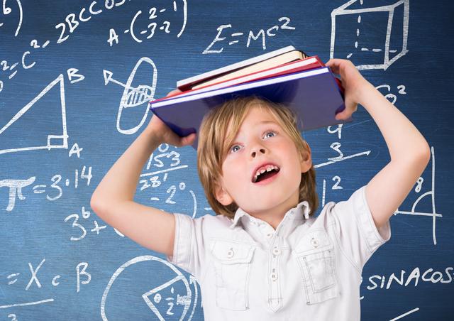 Boy carrying a stack of book against Blackboard with mathematical symbols and formula - Download Free Stock Photos Pikwizard.com