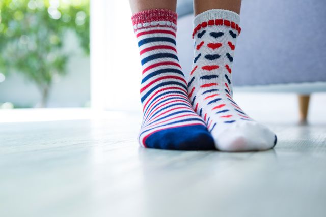 Low section of girl wearing different socks - Download Free Stock Photos Pikwizard.com