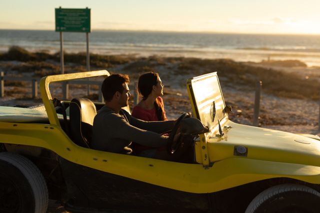 Happy caucasian couple driving beach buggy by sea at sunset, admiring the view - Download Free Stock Photos Pikwizard.com