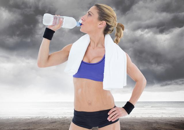 Healthy woman drinking water against stormy sky in background - Download Free Stock Photos Pikwizard.com