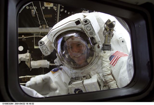 MS Parazynski looks in on his fellow crewmembers during the first EVA of STS-100 - Download Free Stock Photos Pikwizard.com
