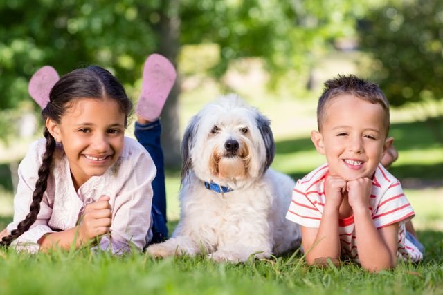 Portrait of siblings having fun with their pet dog - Download Free Stock Photos Pikwizard.com