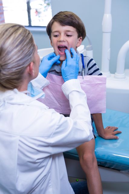 Dentist examining boy at dental clinic - Download Free Stock Photos Pikwizard.com