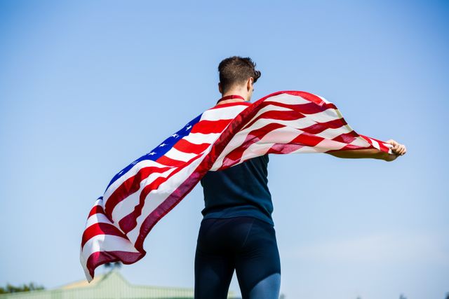 Rear view of athlete holding an american flag