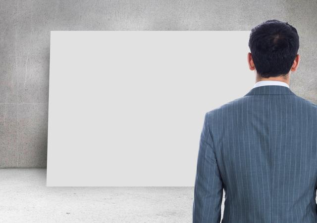 Businessman looking at blank cardwall background - Download Free Stock Photos Pikwizard.com